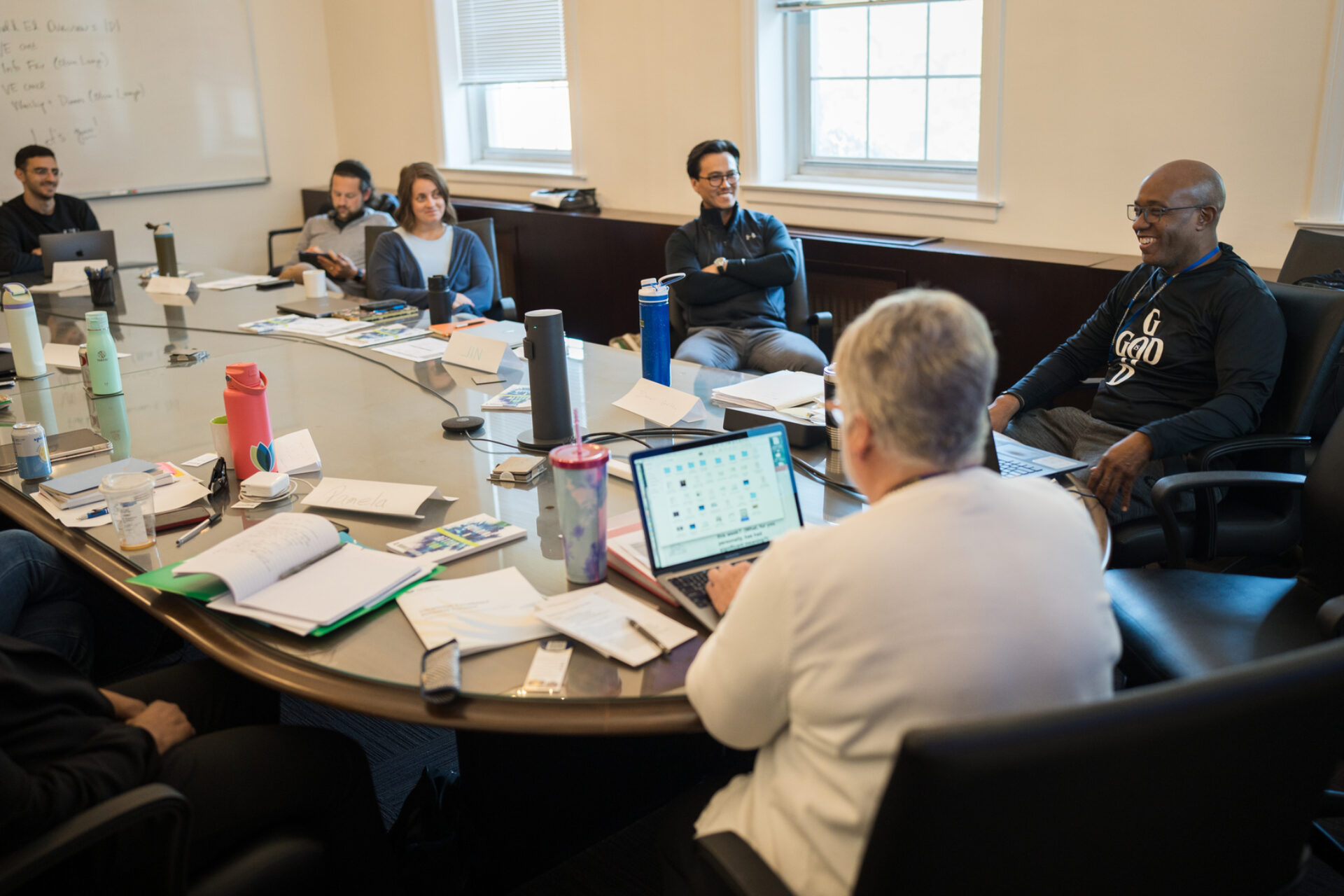 Smiling students around conference table