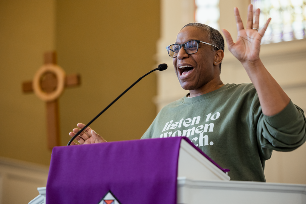 Black woman preaching at lectern