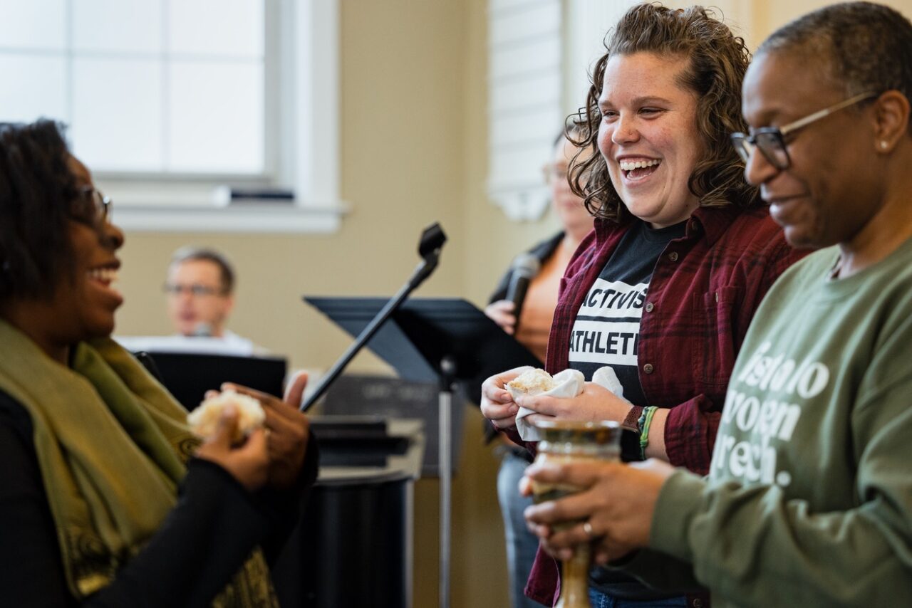 Worship service with piano and people serving communion
