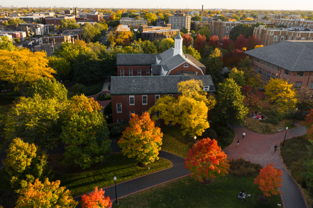 overhead shot of campus buildings in Fall, with trees in red and yellow