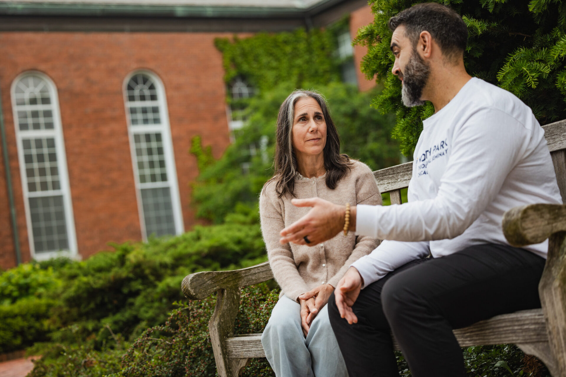 Woman listens thoughtfully to man speaking to her--a spiritual direction conversation