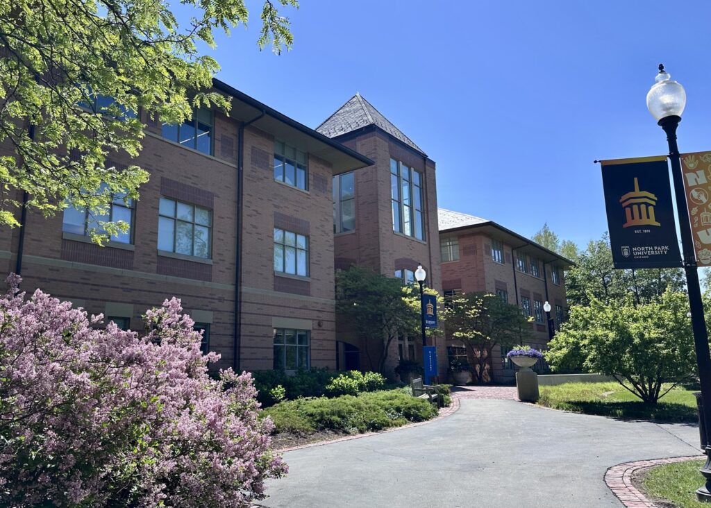 Exterior shot of Brandel Library in spring with pink flowers