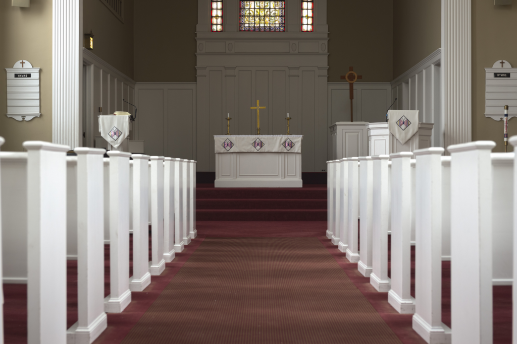Isaacson chapel aisle empty pews with visible pulpit and altar
