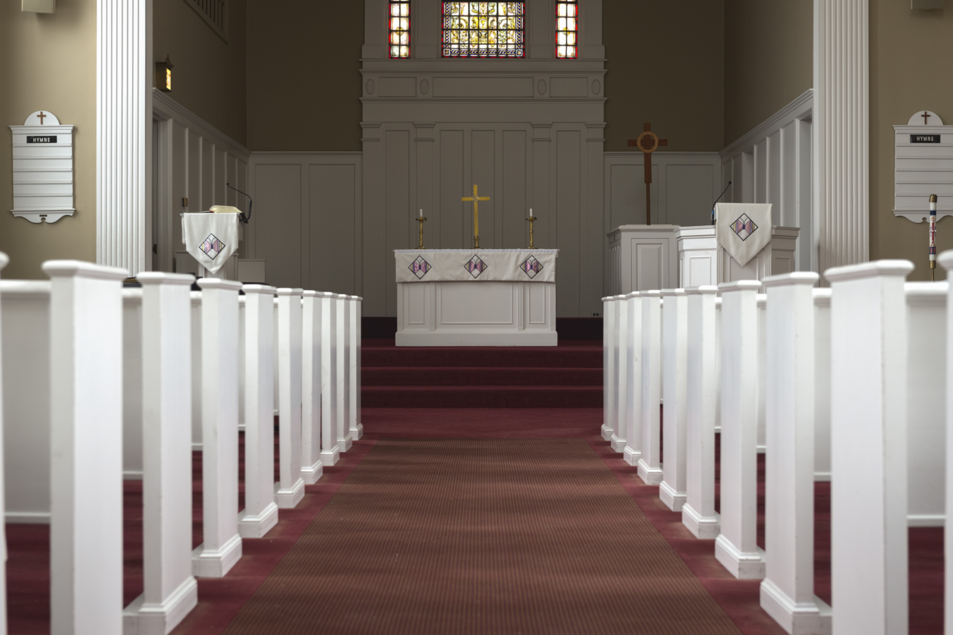 Isaacson chapel aisle empty pews with visible pulpit and altar