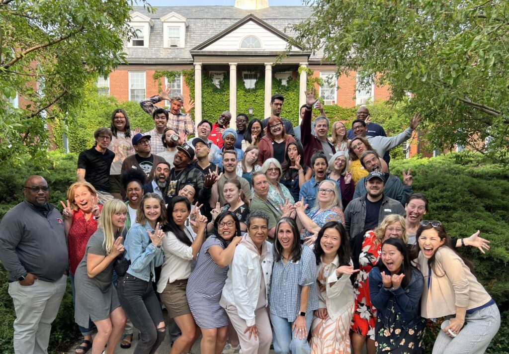 students pose on steps in front of seminary with silly poses