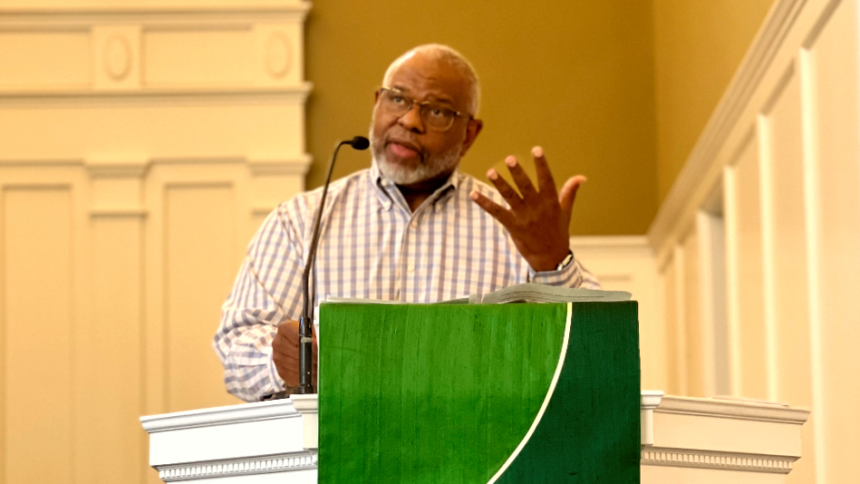 African American preacher behind pulpit delivering a sermon