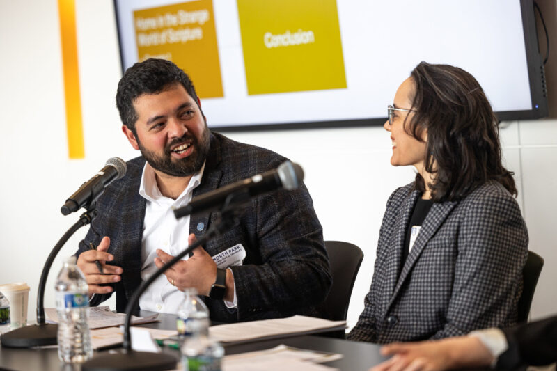 Two seated scholars engage in dialogue