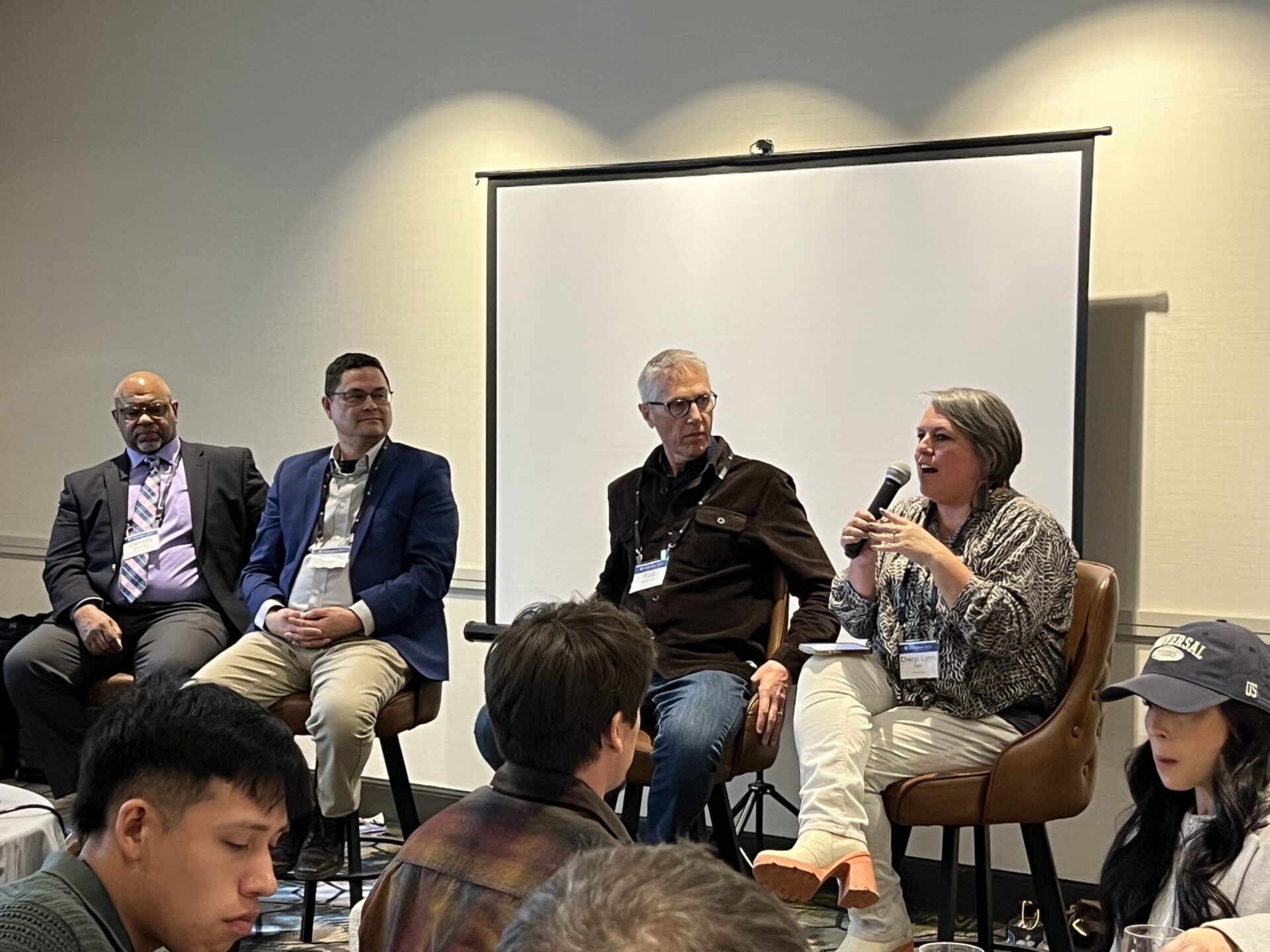 Panel of professors speaking in conference room at Midwinter conference