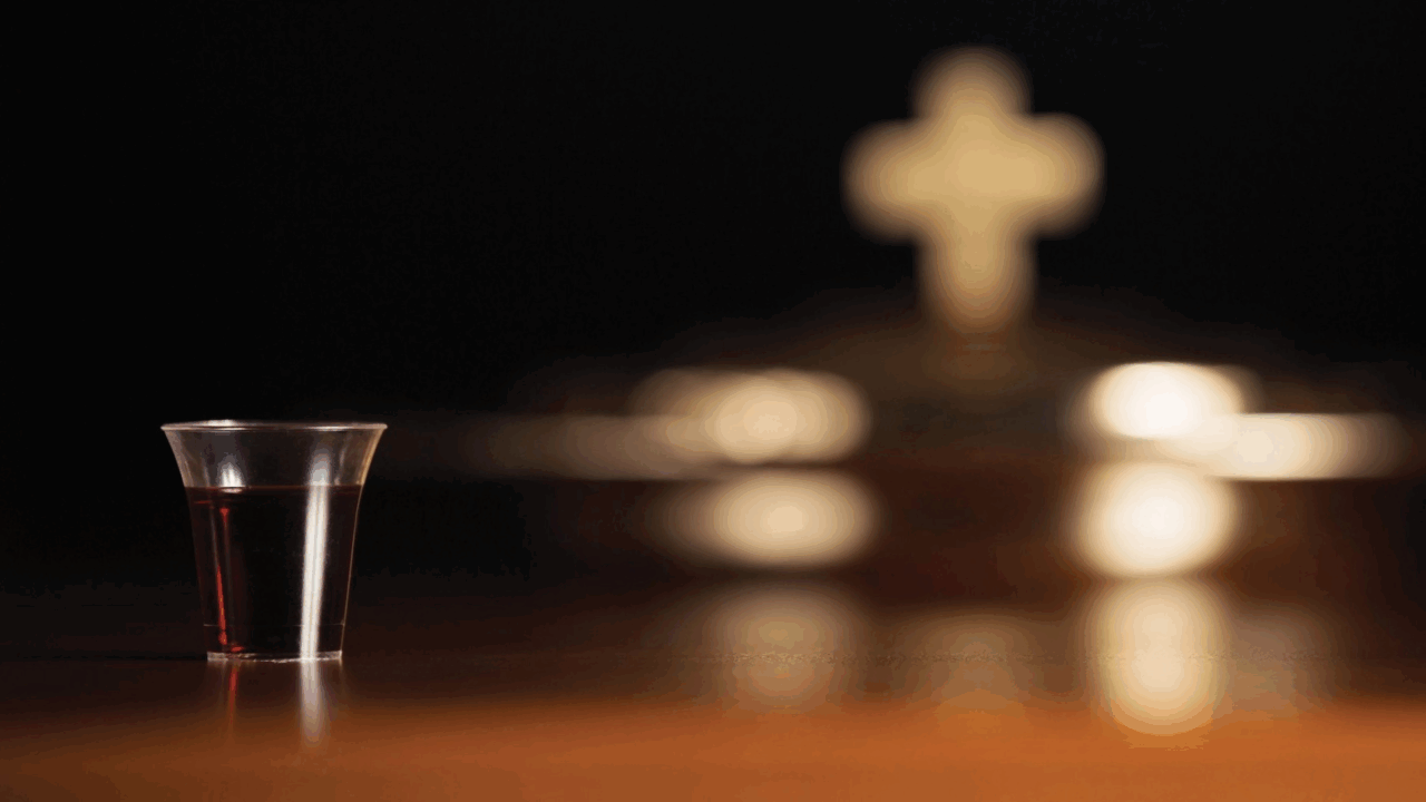 glass communion cup on table