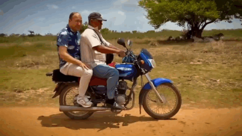 Pastor ride motorcycle on dusty road in Columbia