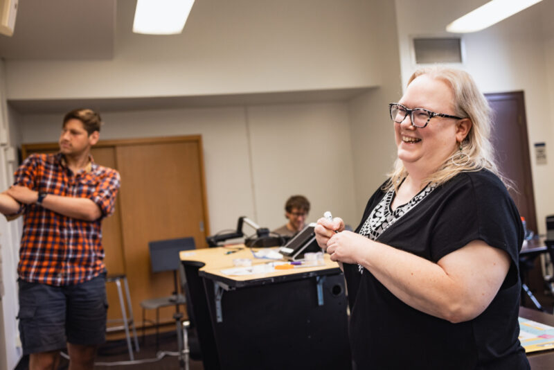 NPTS student laughs while holding white board marker in classroom