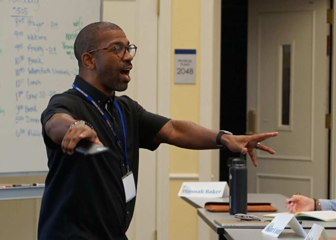 Male instructor teaching in lecture room