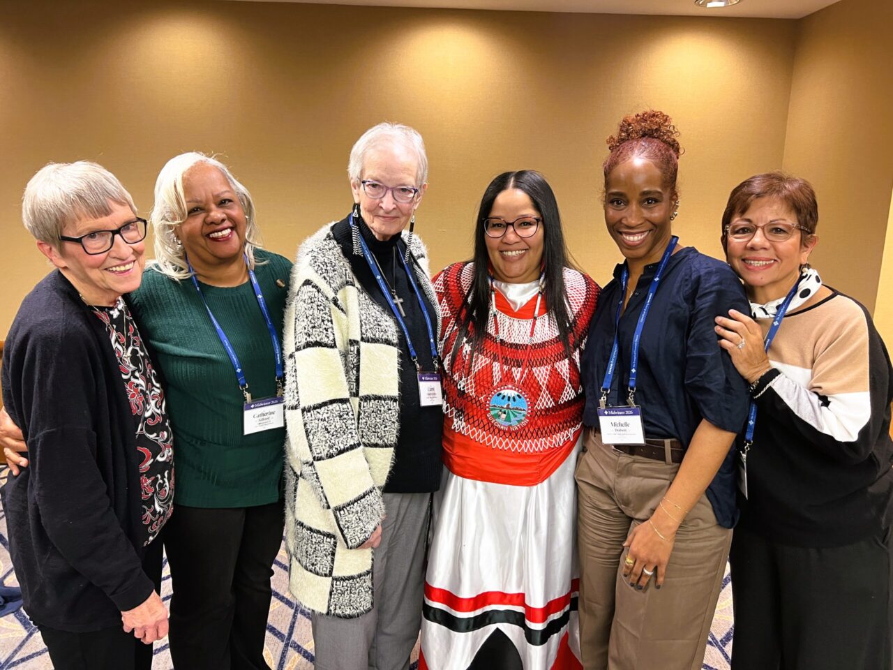 Diverse group of women smile at the camera