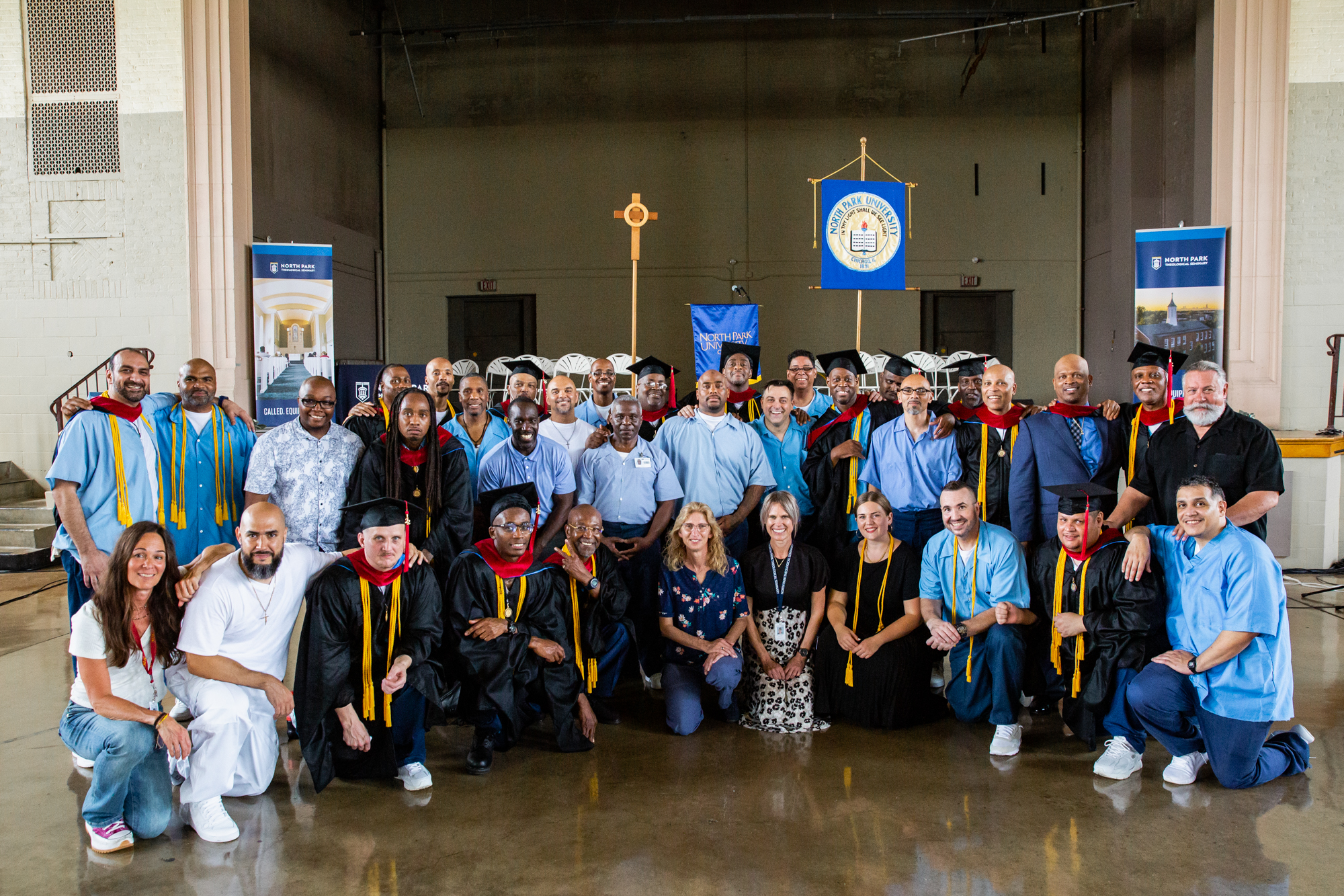Group photo of individuals in custody and individuals in academic regalia